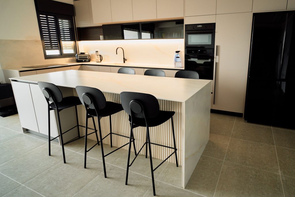 Contemporary kitchen interior featuring island seating and sleek appliances in a minimalist design.